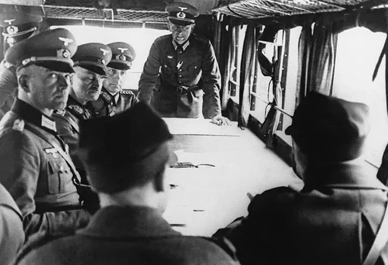 German and Polish military officials negotiate the formal surrender of Warsaw to German forces.