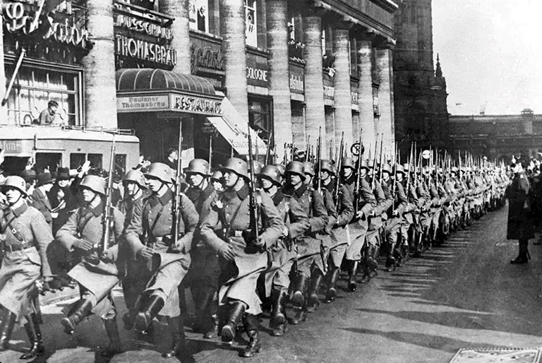 German troops march into the Rhineland thereby breaking the Treaty of Versailles, which had required it to be demilitarised.